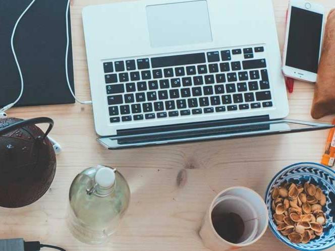 Top view of laptop, snacks, and coffee